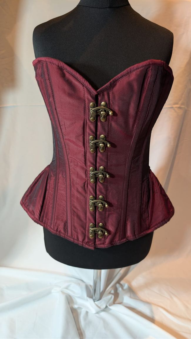 Burgundy corset on a mannequin, original photo