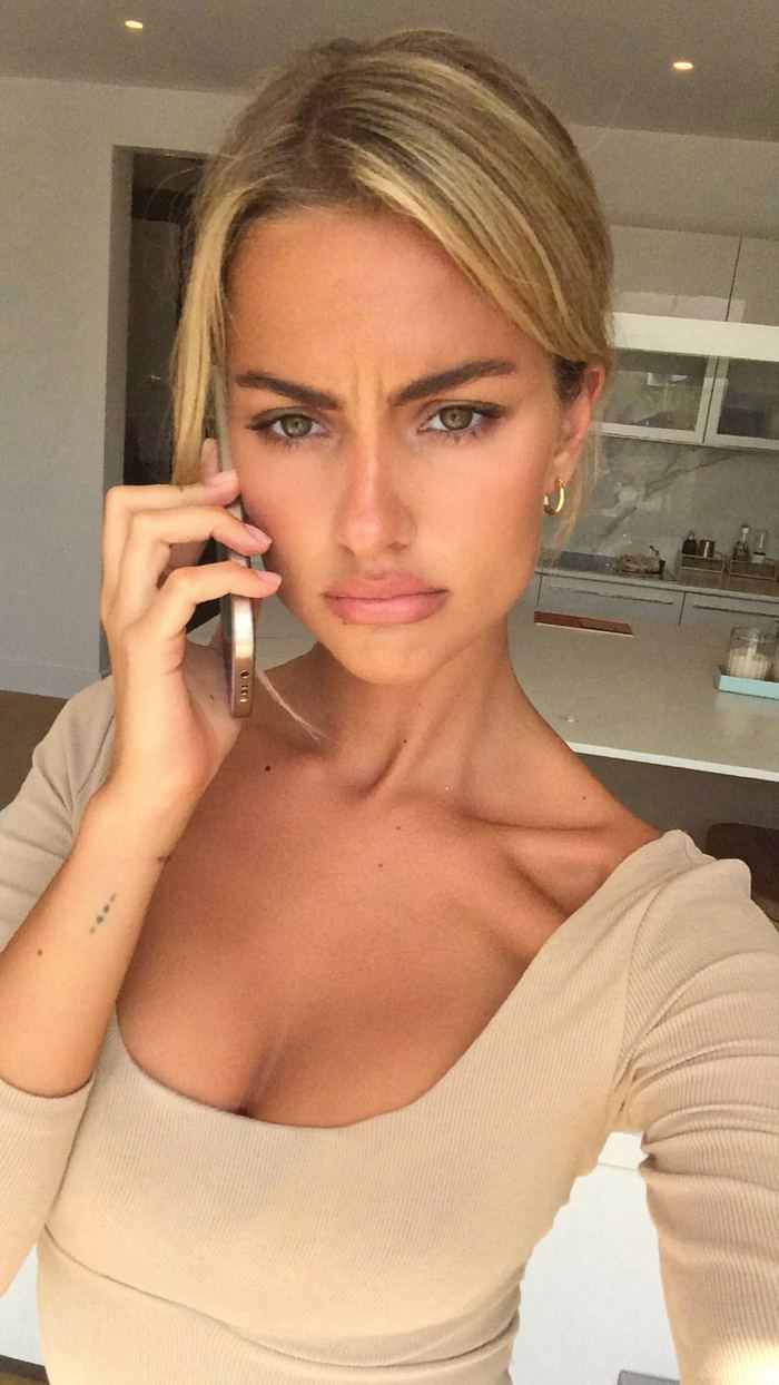 UGC style selfie of a woman frowning on a phone call