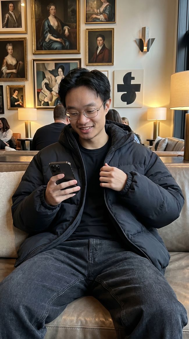 UGC style photo of a man checking his phone in a hotel lounge
