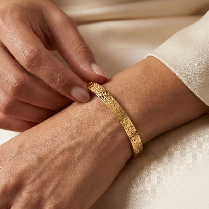 Engraved gold bangle on a wrist, close-up