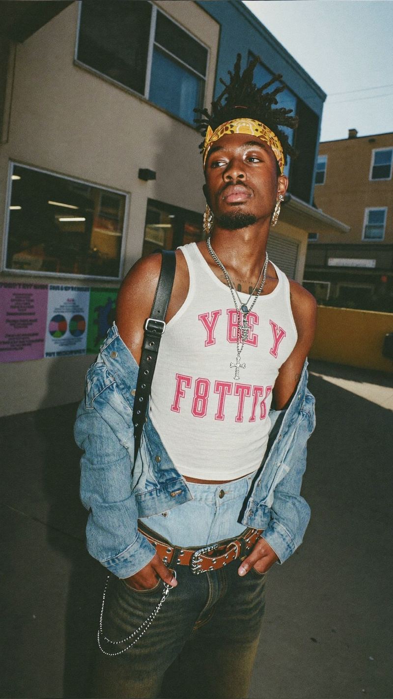 Streetwear look with a denim jacket and graphic tank, film photo