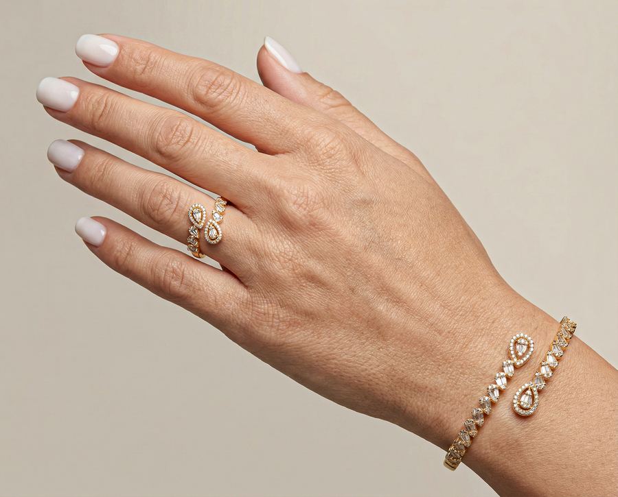 Gold ring and cuff with baguette stones on a hand