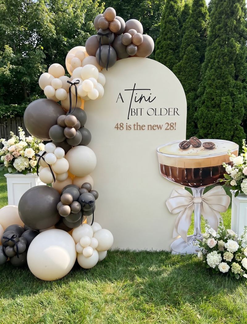 Neutral balloon backdrop with a cocktail cutout
